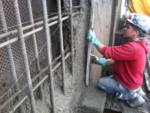 HCM Shotcrete - A six foot screed is used to cut face of wall to guide wires